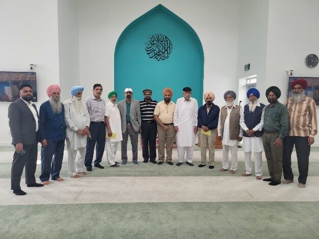 Guests and community members inside Mubarak Mosque's prayer hall during an open house